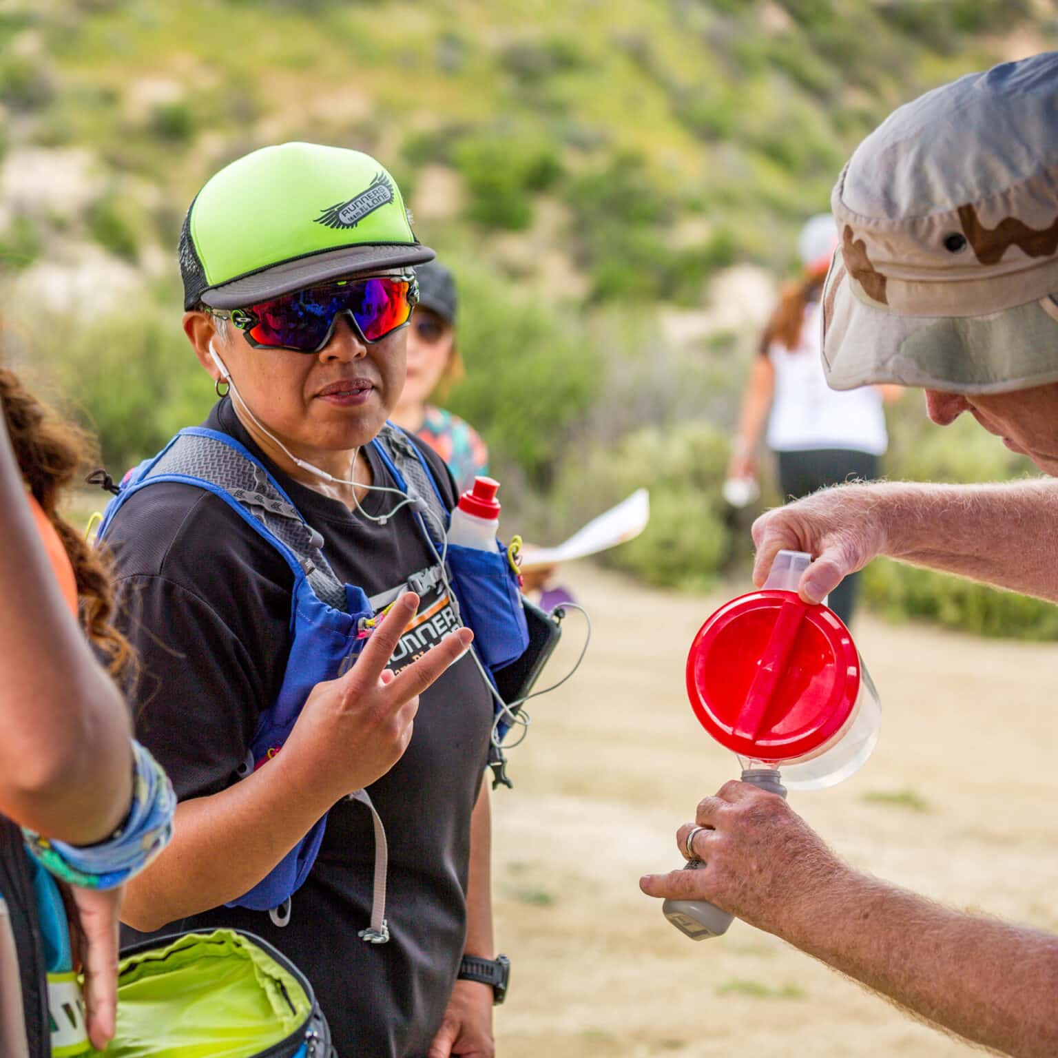 Volunteer filling water bottle